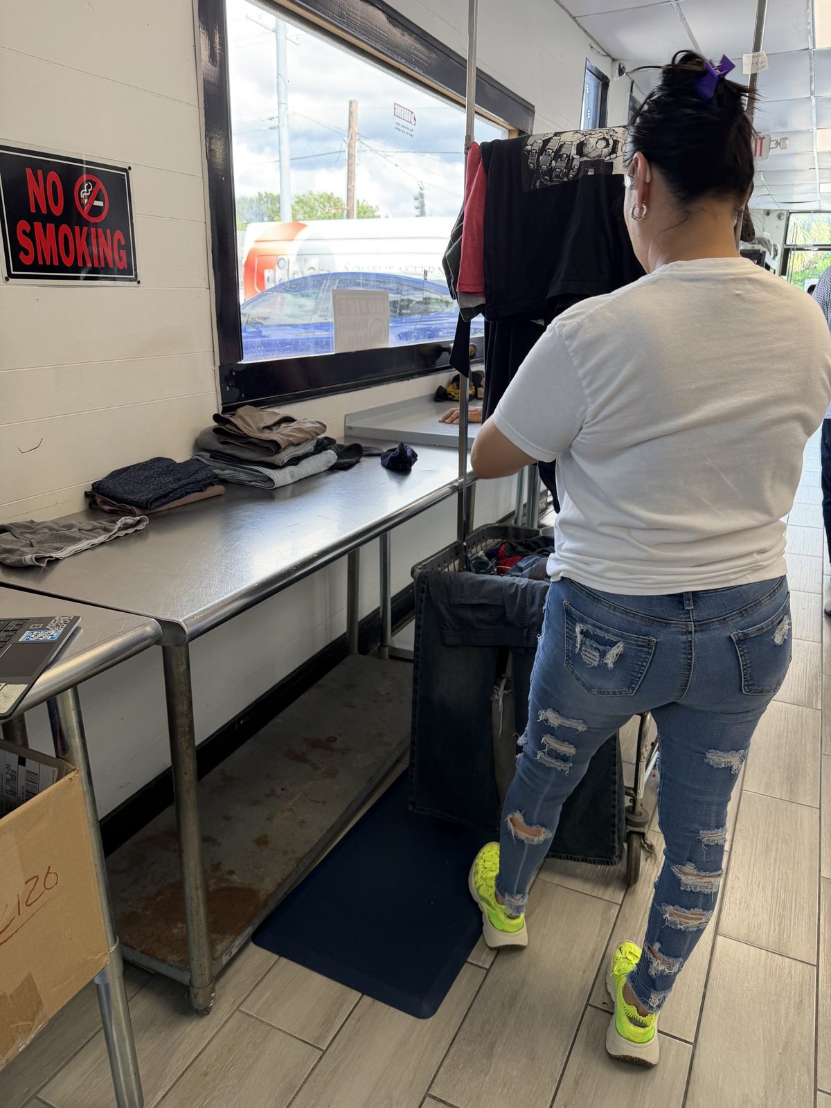 Team member folding at the stainless folding station